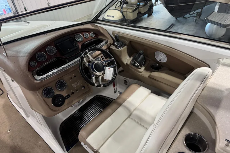 Slide: The Image of Interior of a 2011 Cobalt boat showing steering wheel and control panel. - 8