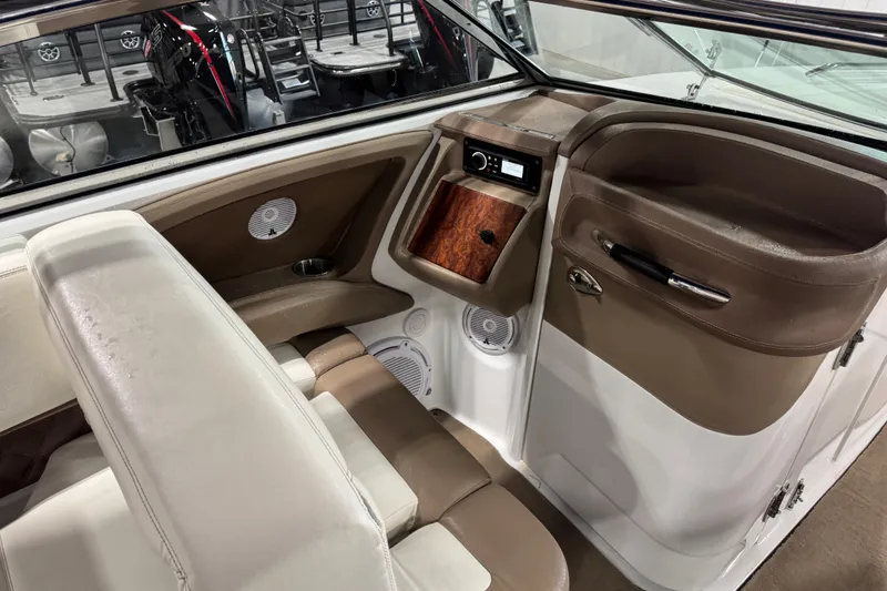 Slide: The Image of 2011 Cobalt boat interior with beige seating, wood accents, and audio system. - 9