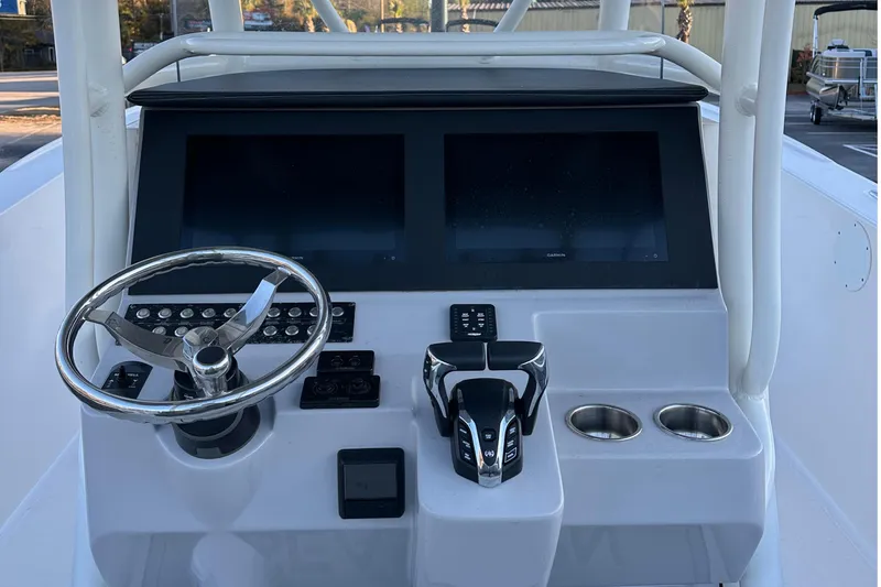Slide: The Image of 2025 Sea Born SX281 Offshore boat dashboard with dual screens and steering wheel. - 6