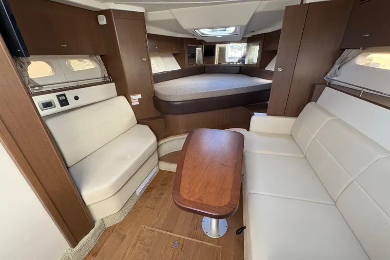 Slide: The Image of Interior of 2018 Sea Ray Sundancer 350 Coupe with elegant seating and wooden table. - 16