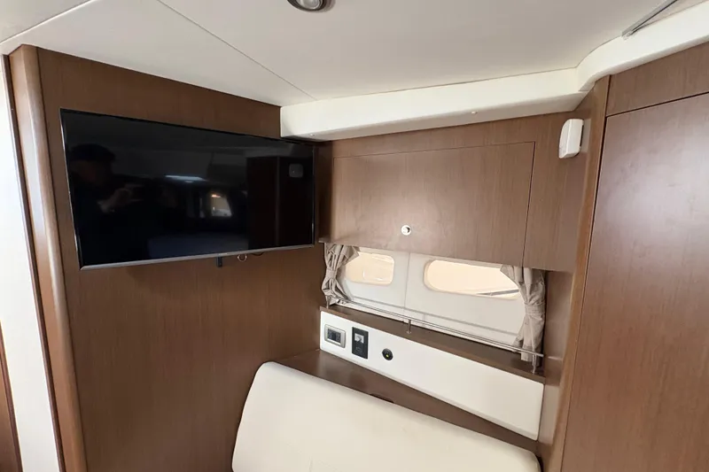 Slide: The Image of Interior of 2018 Sea Ray Sundancer 350 Coupe with TV and wooden cabinetry. - 17
