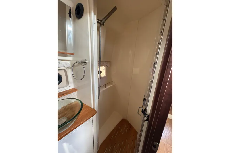 Slide: The Image of 2018 Sea Ray Sundancer 350 Coupe bathroom with shower and glass sink. - 19