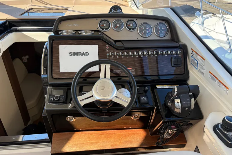 Slide: The Image of 2018 Sea Ray Sundancer 350 Coupe helm with Simrad display and controls. - 9