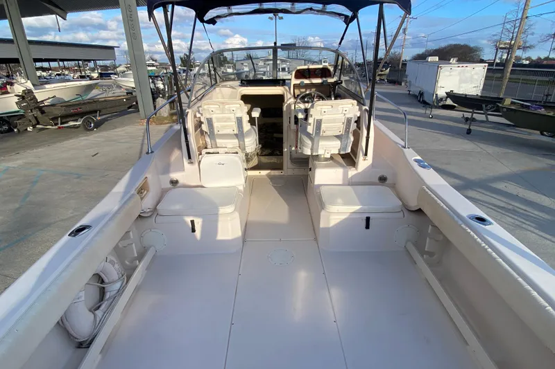 Slide: The Image of 1999 Grady-White Seafarer 228 boat interior with seating and steering wheel. - 10