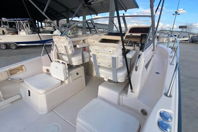 Slide: The Image of 1999 Grady-White Seafarer 228 boat interior with seating and motor view. - 12