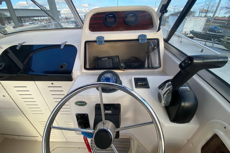 Slide: The Image of 1999 Grady-White Seafarer 228 cabin interior with seating and marine toilet. - 18