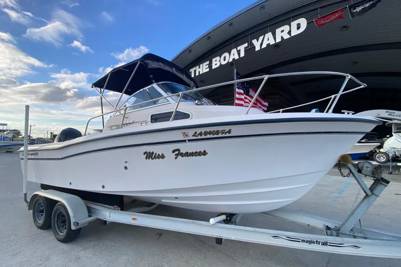 Slide: The Image of 1999 Grady-White Seafarer 228 boat on trailer at The Boat Yard dealership. - 2
