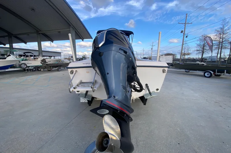 Slide: The Image of 1999 Grady-White Seafarer 228 boat on trailer, under a blue sky. - 5