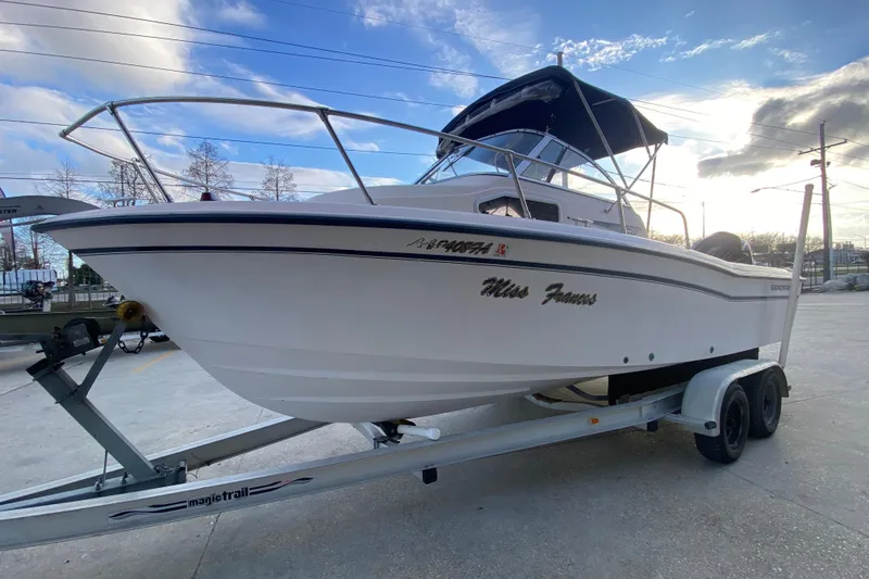Slide: The Image of 1999 Grady-White Seafarer 228 boat interior with seating and steering console. - 8