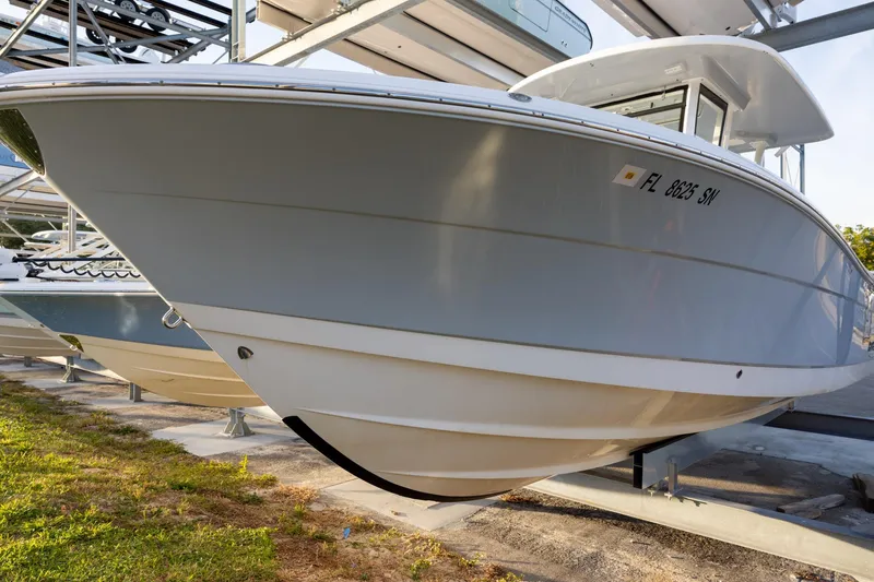 The Image of 2020 Robalo R302 Center Console boat on a lift, side view. - 0