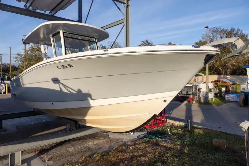 Slide: The Image of 2020 Robalo R302 Center Console boat on a lift, side view. - 1