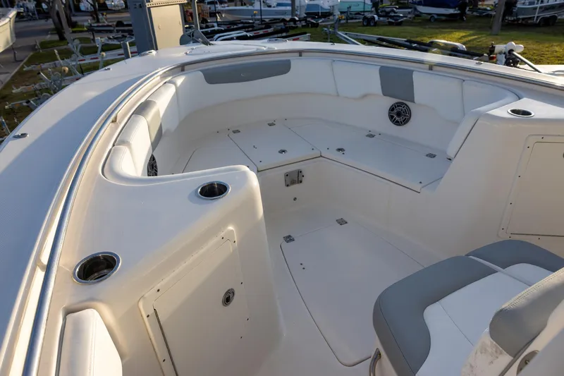 Slide: The Image of 2020 Robalo R302 Center Console boat interior with seating and cup holders. - 10