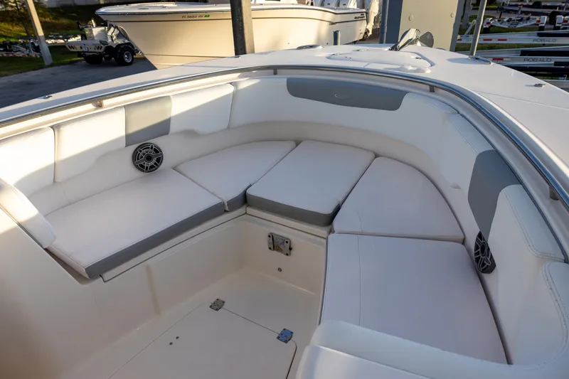 Slide: The Image of 2020 Robalo R302 Center Console boat with spacious seating area and speakers. - 12
