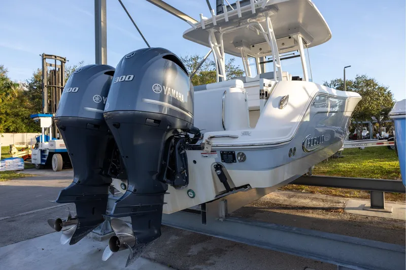Slide: The Image of 2020 Robalo R302 Center Console boat with dual Yamaha 300 engines on display. - 2