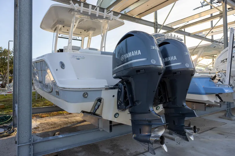 Slide: The Image of 2020 Robalo R302 Center Console boat with dual Yamaha 300 engines in storage. - 3