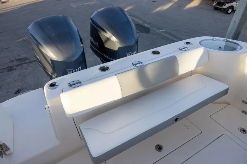 Slide: The Image of 2020 Robalo R302 Center Console boat with dual Yamaha engines and seating area. - 6