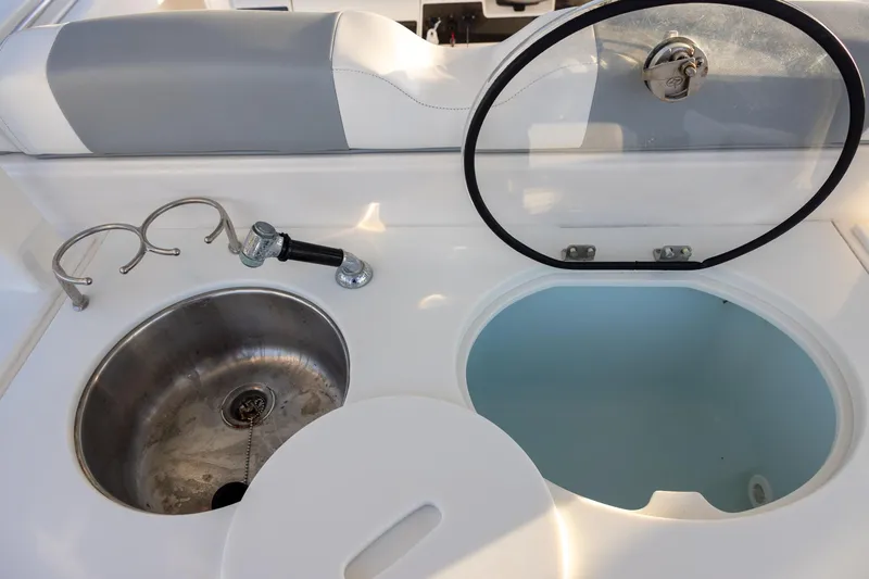 Slide: The Image of 2020 Robalo R302 Center Console boat sink and storage compartment. - 7