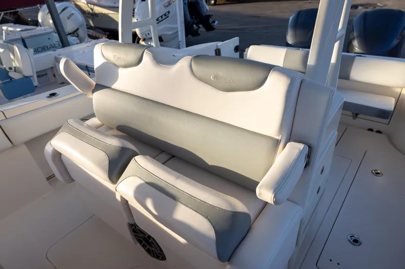 Slide: The Image of 2020 Robalo R302 Center Console boat seating area with cushioned seats and armrests. - 8