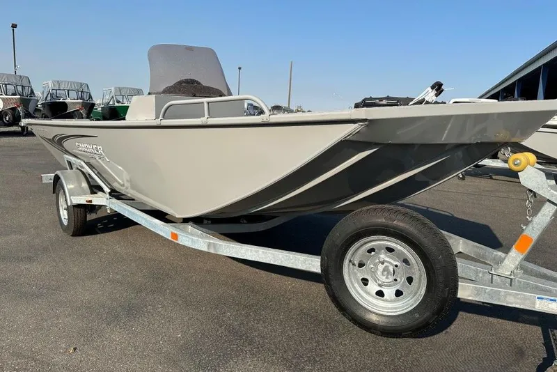 The Image of 2025 Smoker Craft Sportsman Pro 1866 SC boat on trailer, parked outdoors. - 0