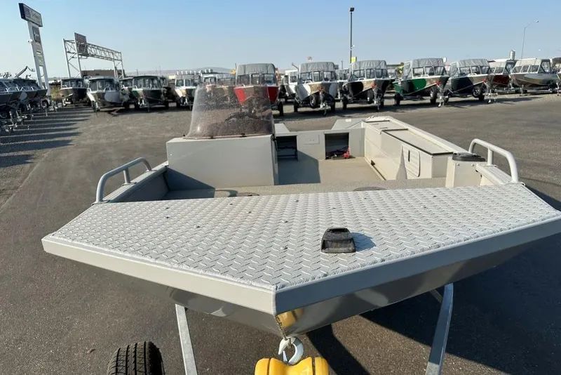 Slide: The Image of 2025 Smoker Craft Sportsman Pro 1866 SC boat displayed in a dealership lot. - 2