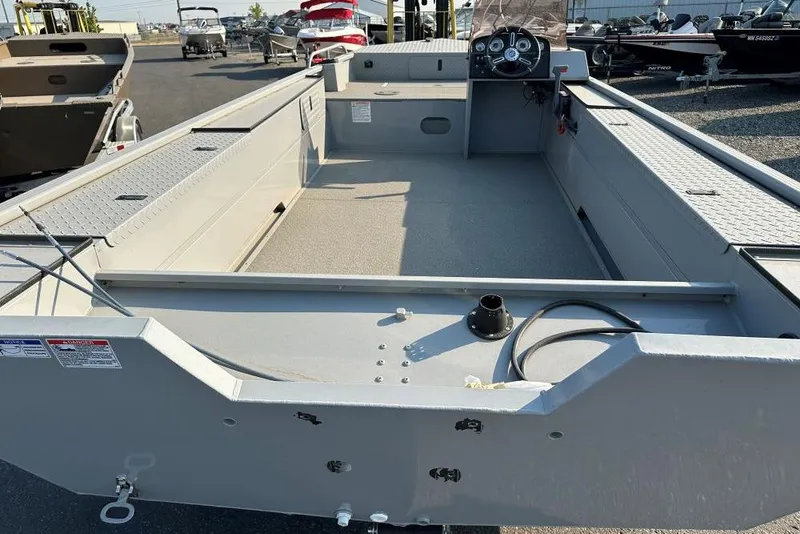 Slide: The Image of 2025 Smoker Craft Sportsman Pro 1866 SC boat interior, featuring spacious deck and steering console. - 3