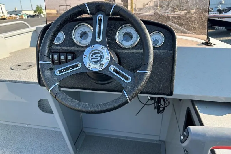 Slide: The Image of 2025 Smoker Craft Sportsman Pro 1866 SC boat dashboard with steering wheel and gauges. - 4