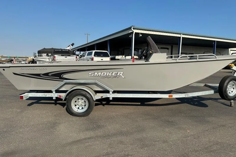 Slide: The Image of 2025 Smoker Craft Sportsman Pro 1866 SC boat on trailer, parked outdoors. - 1