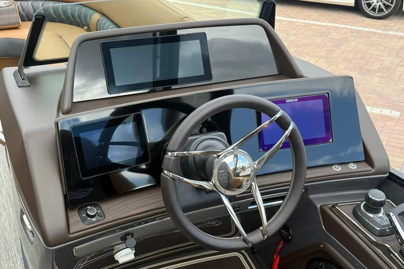 Slide: The Image of Steering console of 2026 Bennington 27 QSBAT2 with digital displays and controls. - 16