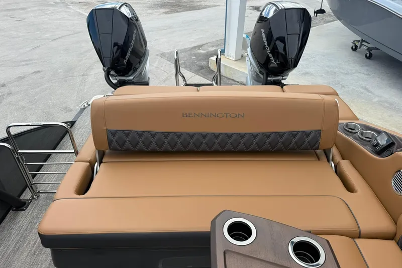 Slide: The Image of 2026 Bennington 27 QSBAT2 boat with tan seating and dual Mercury engines. - 18