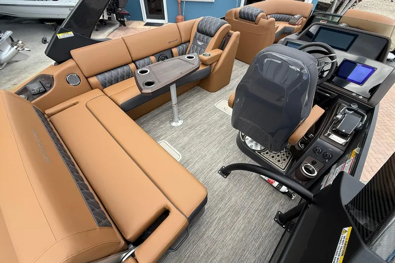 Slide: The Image of Luxurious interior of 2026 Bennington 27 QSBAT2 pontoon boat with tan seating and modern dashboard. - 19