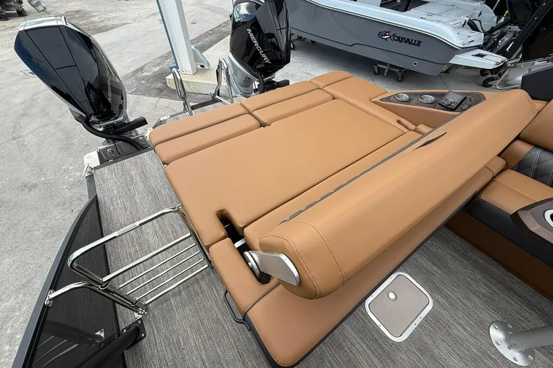 Slide: The Image of 2026 Bennington 27 QSBAT2 boat with tan seating and dual outboard motors. - 20