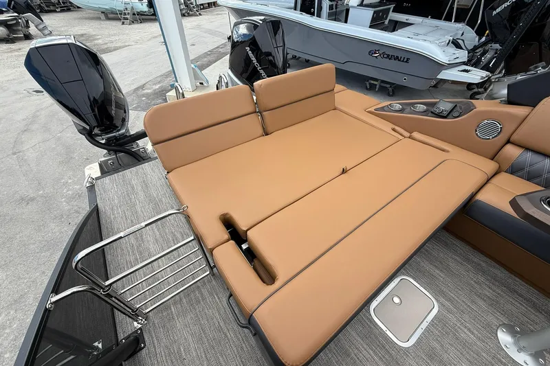 Slide: The Image of 2026 Bennington 27 QSBAT2 boat with tan seating and modern design features. - 22