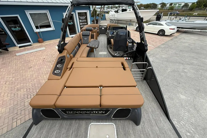 Slide: The Image of 2026 Bennington 27 QSBAT2 pontoon boat with luxurious tan seating and modern design. - 23