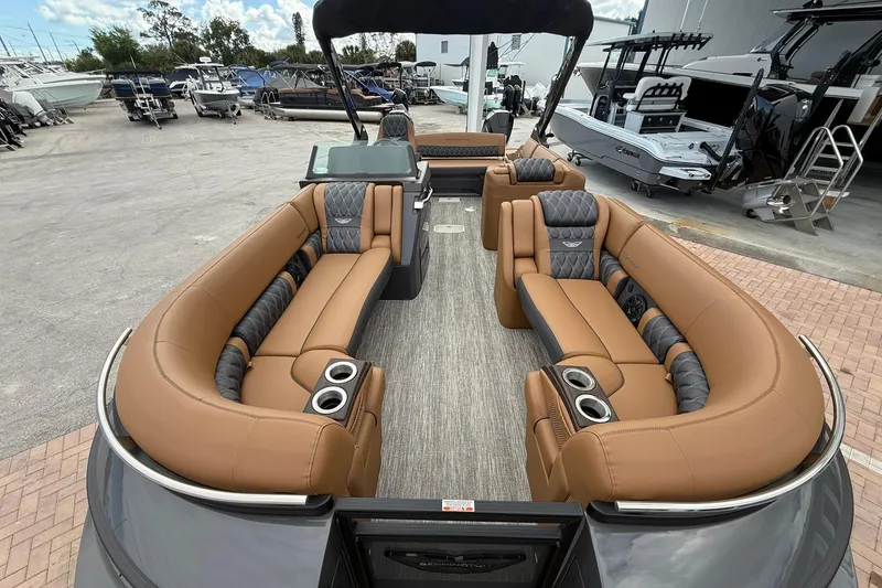 Slide: The Image of Luxurious interior of 2026 Bennington 27 QSBAT2 pontoon boat with tan seating and cup holders. - 7