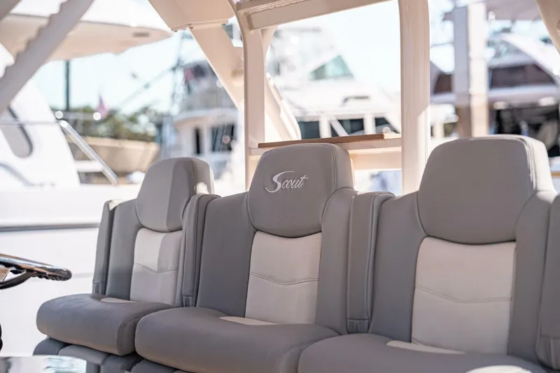 Slide: The Image of 2020 Scout 380 LXF boat seats with embroidered logo, docked in marina. - 10