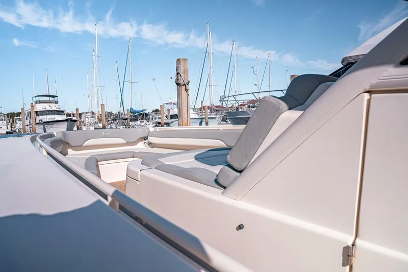 Slide: The Image of 2020 Scout 380 LXF luxury boat interior at marina with clear blue sky. - 11