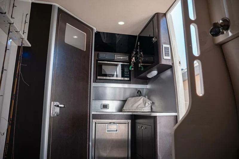 Slide: The Image of Interior of 2020 Scout 380 LXF boat featuring modern kitchenette and storage. - 20
