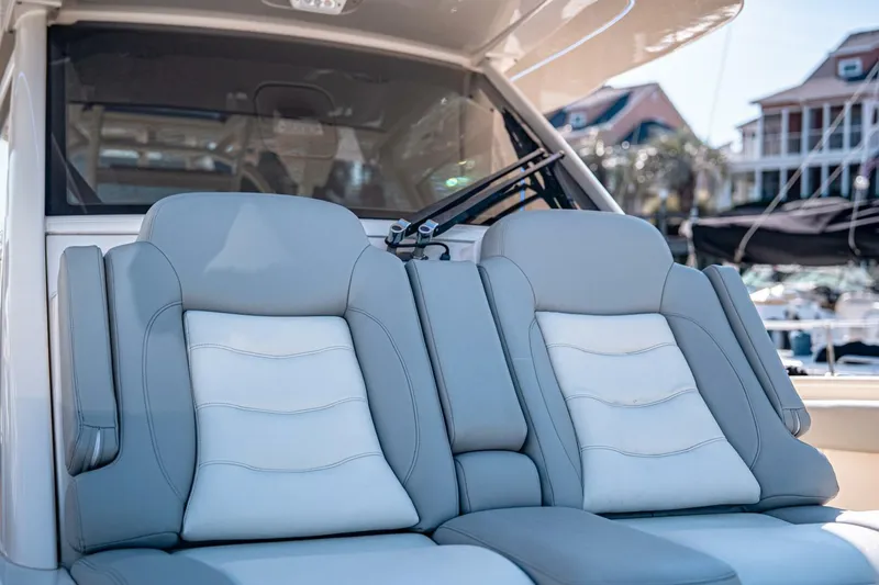 Slide: The Image of Luxury seating on 2020 Scout 380 LXF boat, featuring plush gray and white upholstery. - 22