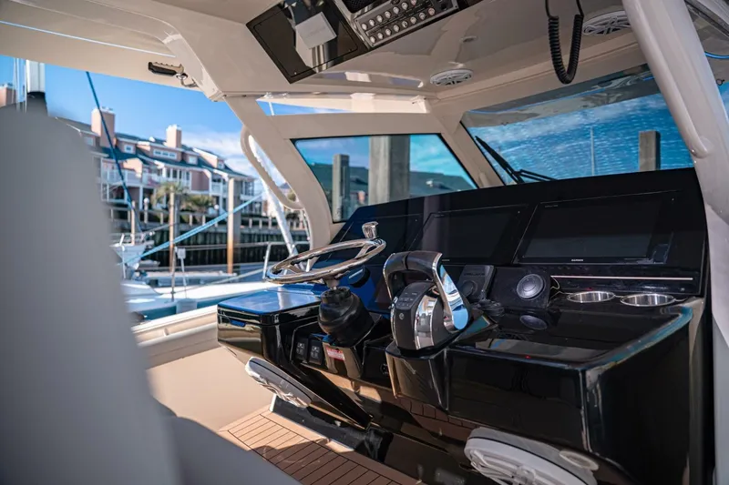 Slide: The Image of 2020 Scout 380 LXF boat cockpit with modern controls and waterfront view. - 27