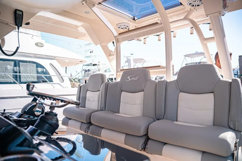 Slide: The Image of Luxury seating on 2020 Scout 380 LXF boat, featuring plush gray and white upholstery. - 30