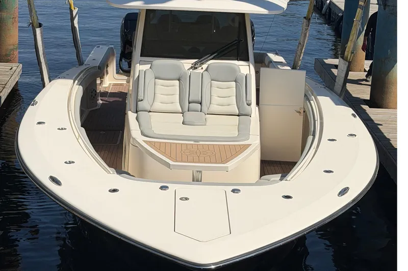 Slide: The Image of 2020 Scout 380 LXF luxury boat docked, featuring sleek design and comfortable seating. - 34