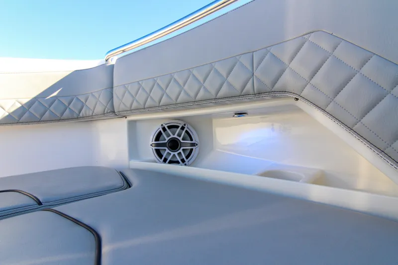 Slide: The Image of Luxurious interior of 2023 Pursuit DC 295 Dual Console with quilted upholstery and speaker. - 11
