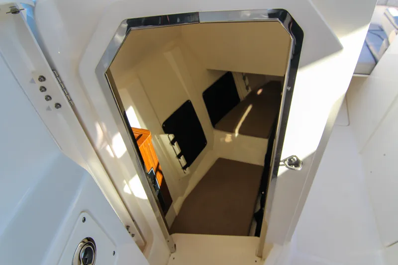 Slide: The Image of 2023 Pursuit DC 295 Dual Console cabin interior with open door view. - 15