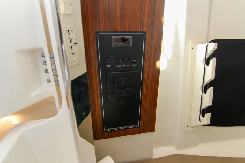 Slide: The Image of 2023 Pursuit DC 295 Dual Console interior control panel with wood finish. - 17