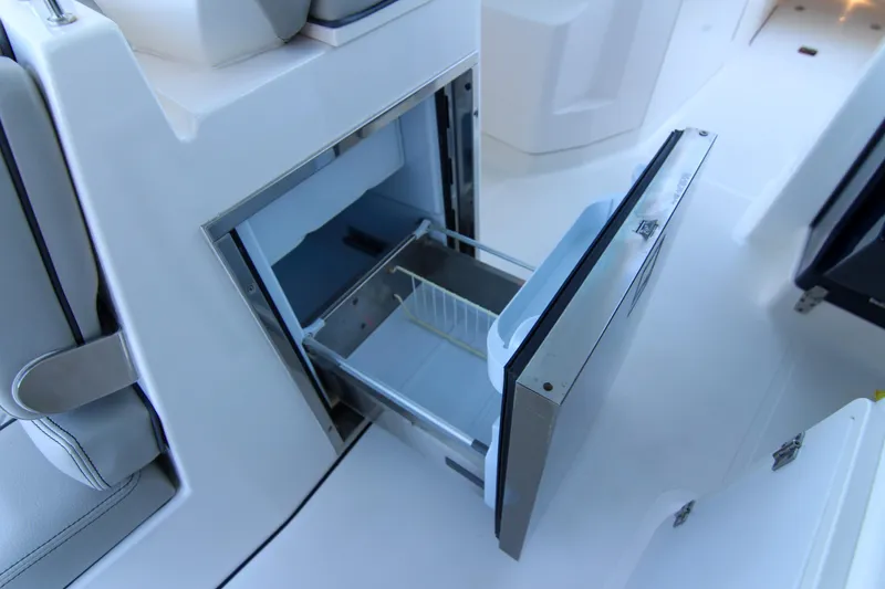 Slide: The Image of Open storage compartment on 2023 Pursuit DC 295 Dual Console boat. - 20
