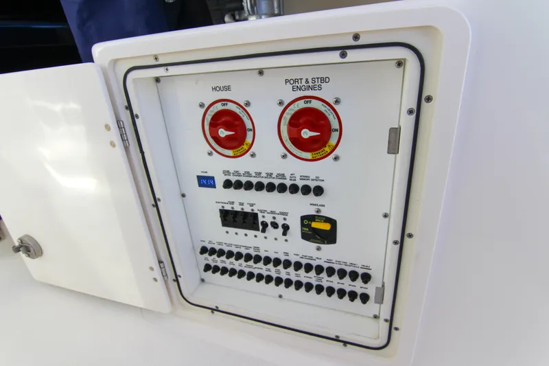 Slide: The Image of Control panel of 2023 Pursuit DC 295 Dual Console boat, featuring switches and dials. - 21