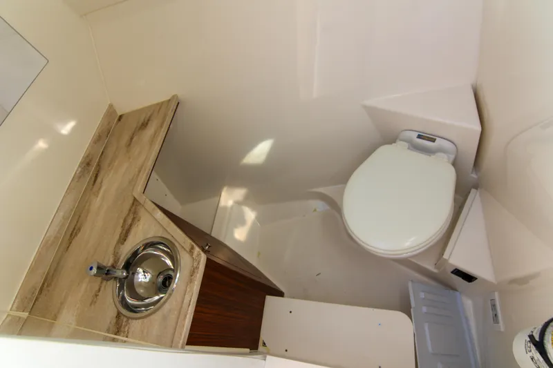 Slide: The Image of 2023 Pursuit DC 295 Dual Console boat bathroom with sink and toilet. - 22