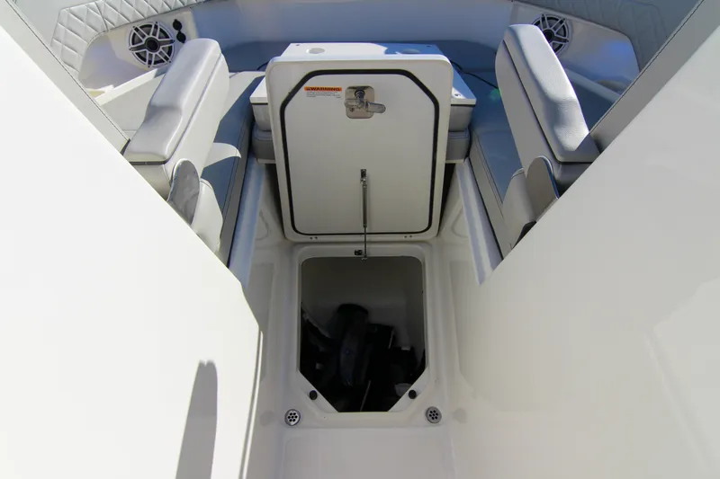 Slide: The Image of 2023 Pursuit DC 295 Dual Console boat interior with storage compartment open. - 34