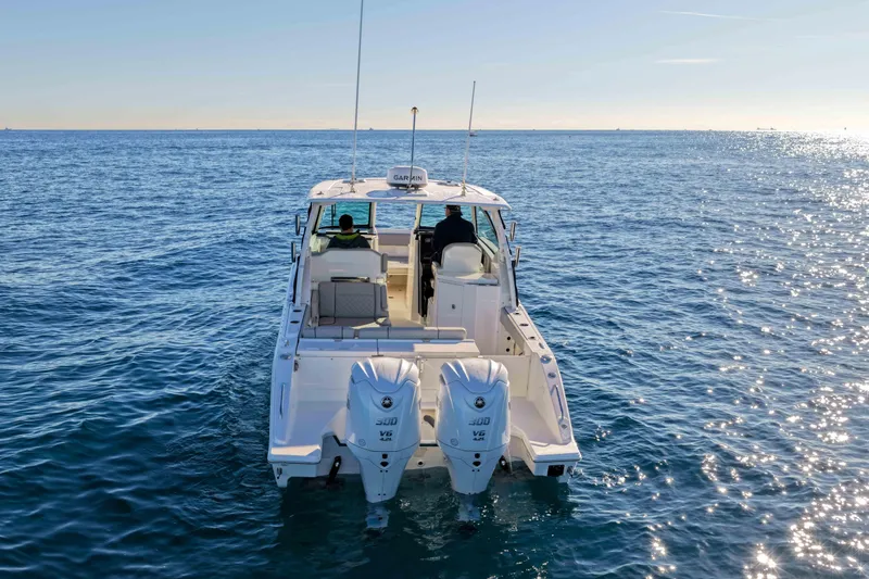 Slide: The Image of 2023 Pursuit DC 295 Dual Console boat cruising on open water. - 35