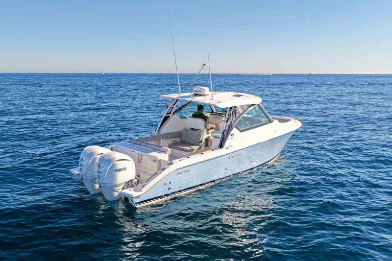 Slide: The Image of 2023 Pursuit DC 295 Dual Console boat cruising on open blue water. - 38